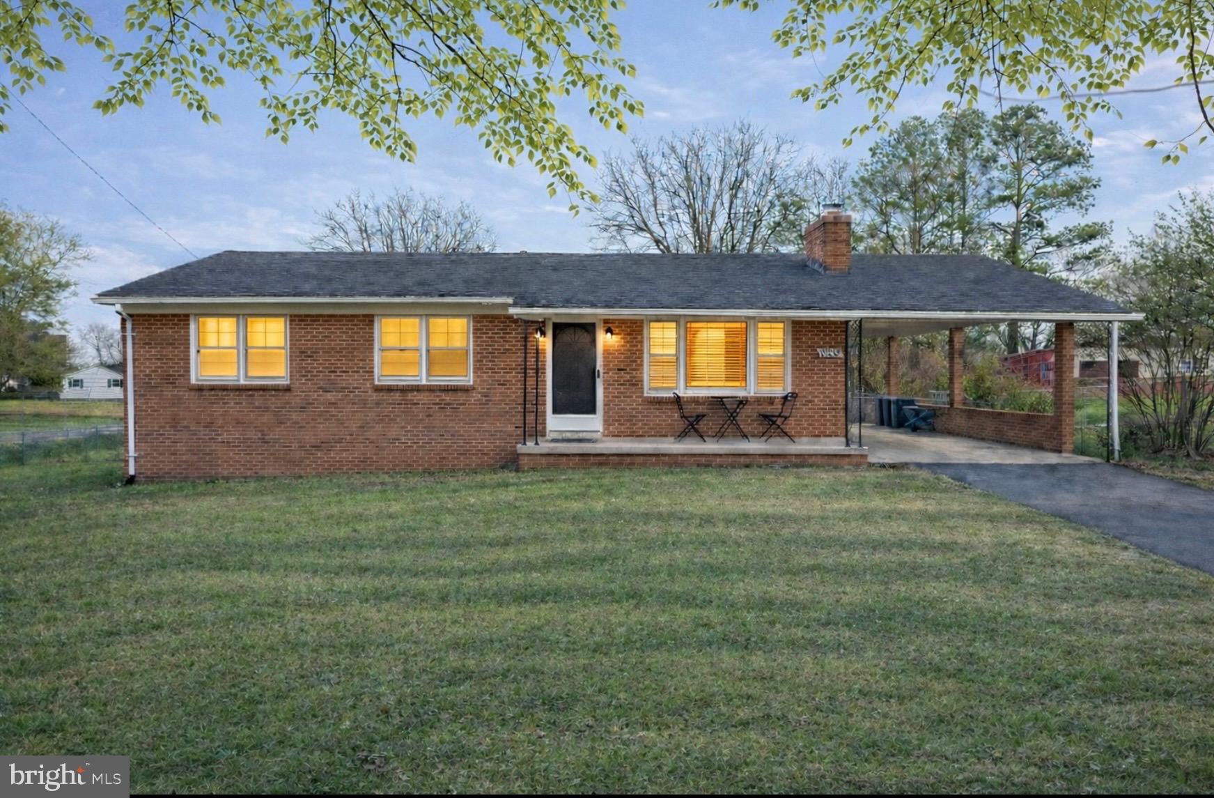 a view of house with a backyard