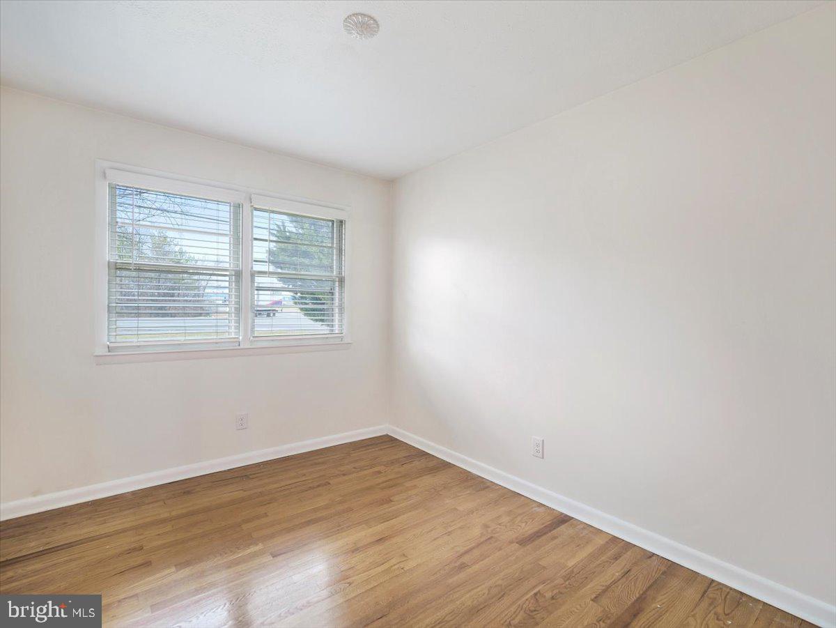 570 Welltown Road Winchester, VA 22603 - Photo 14 of 29 an empty room with wooden floor and windows