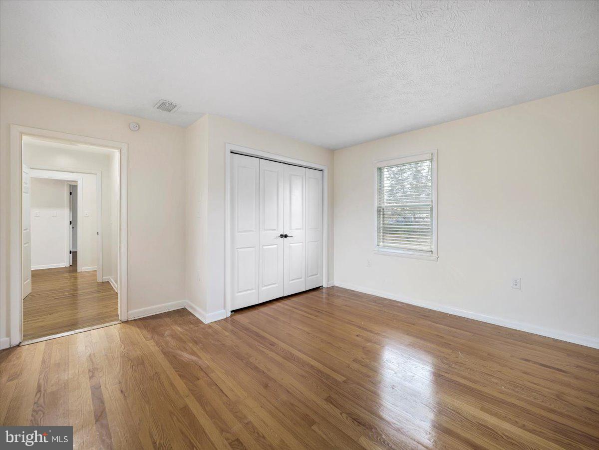 570 Welltown Road Winchester, VA 22603 - Photo 21 of 29 a view of an empty room with wooden floor and a window