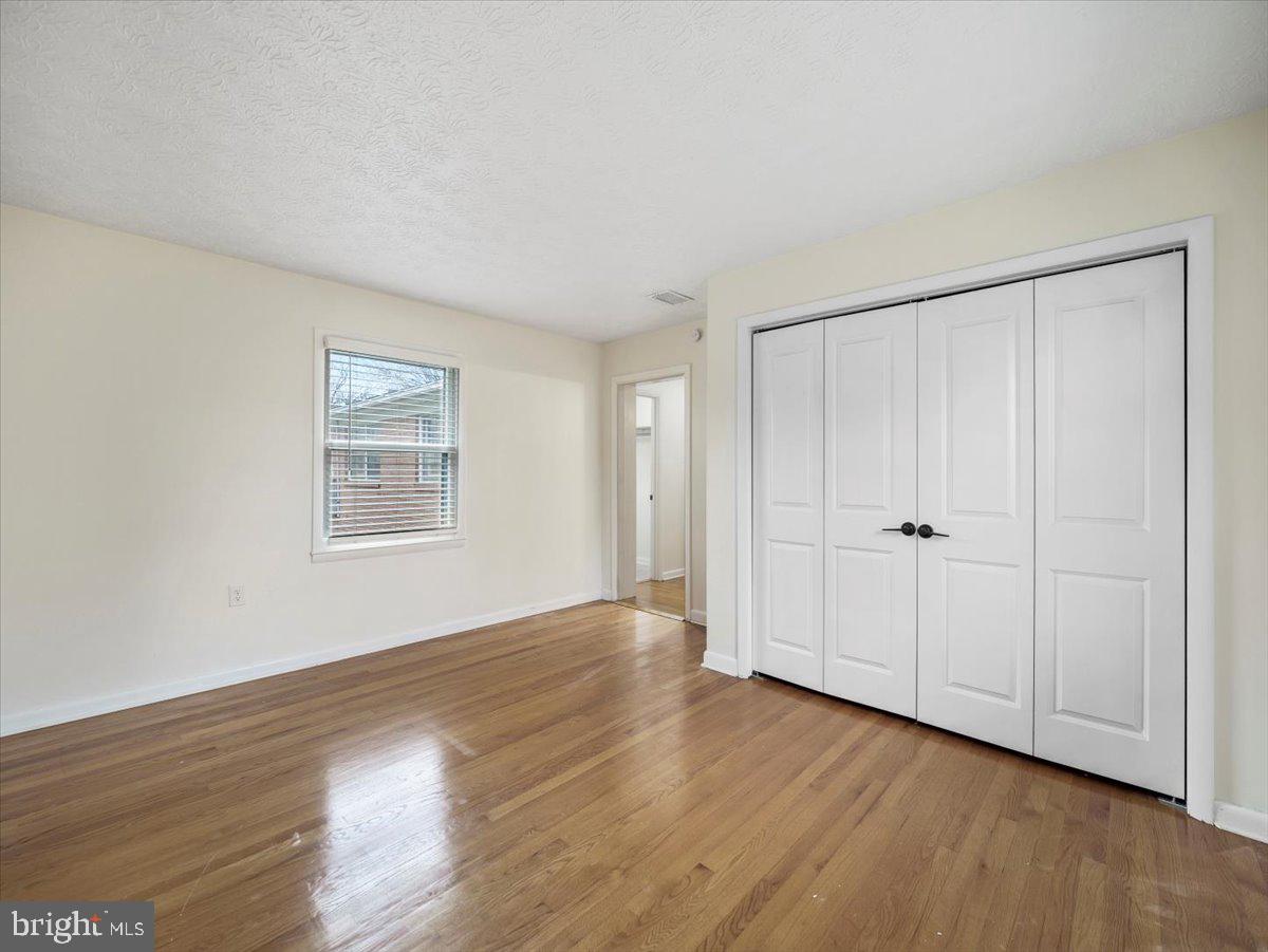 570 Welltown Road Winchester, VA 22603 - Photo 22 of 29 a view of an empty room with wooden floor and a window