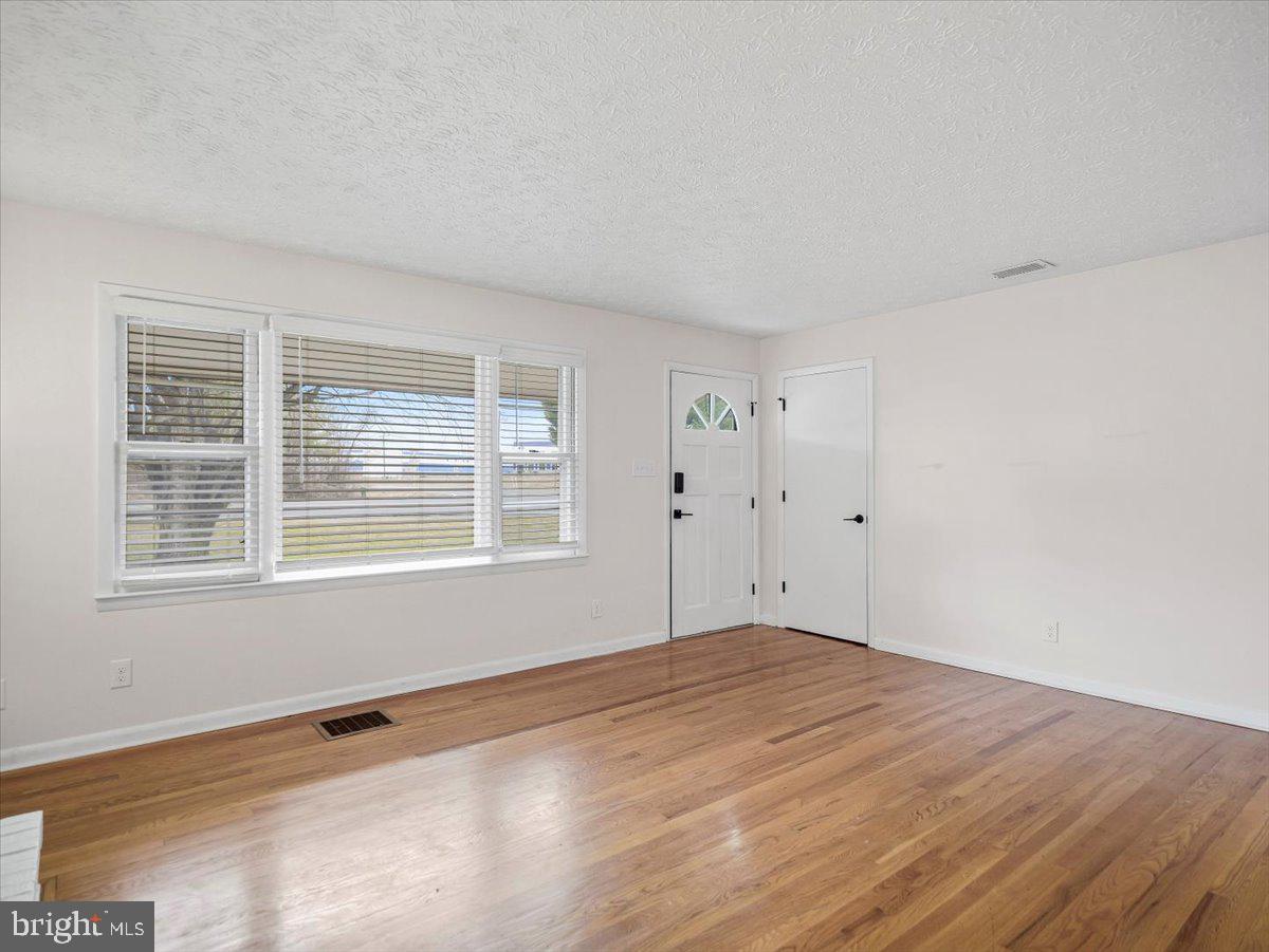 570 Welltown Road Winchester, VA 22603 - Photo 6 of 29 a view of empty room with wooden floor and fan