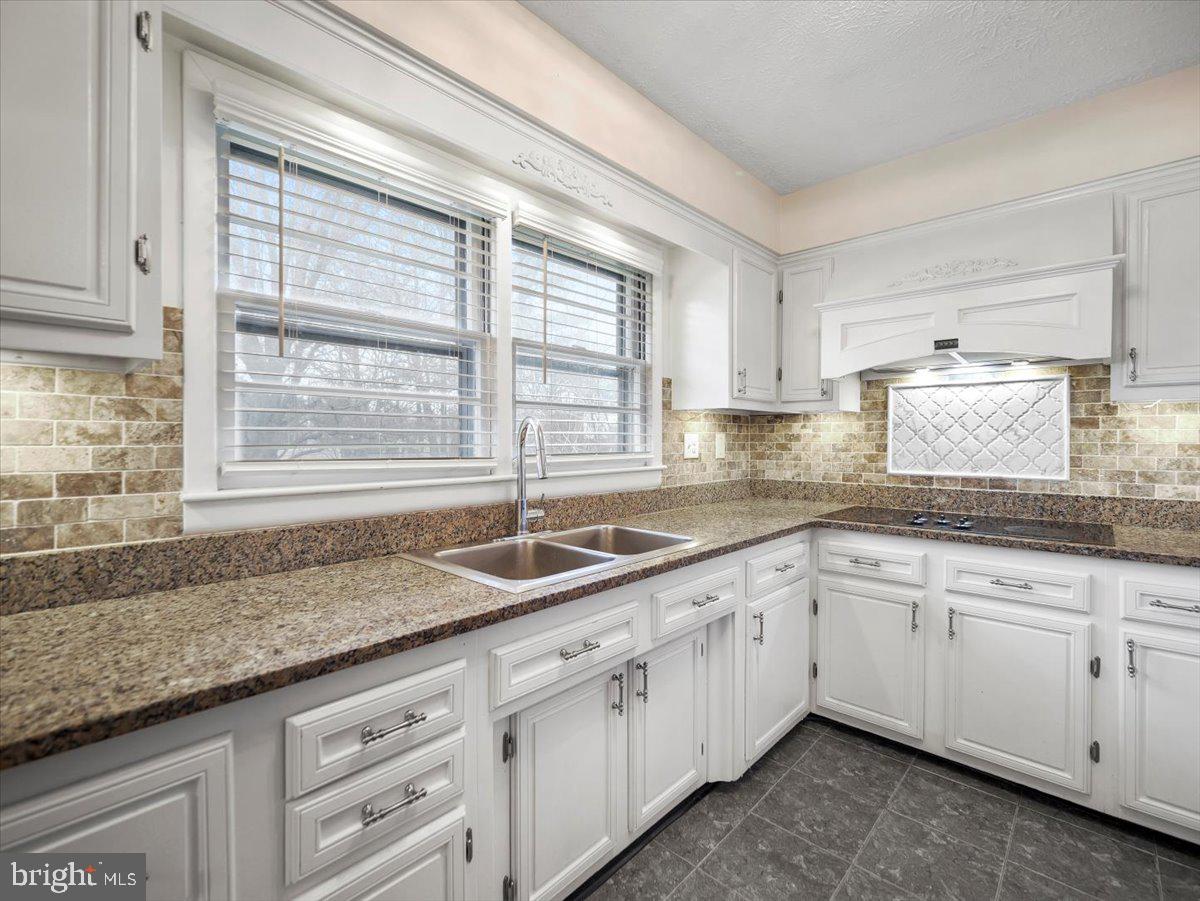 570 Welltown Road Winchester, VA 22603 - Photo 7 of 29 a kitchen with granite countertop white cabinets and a window