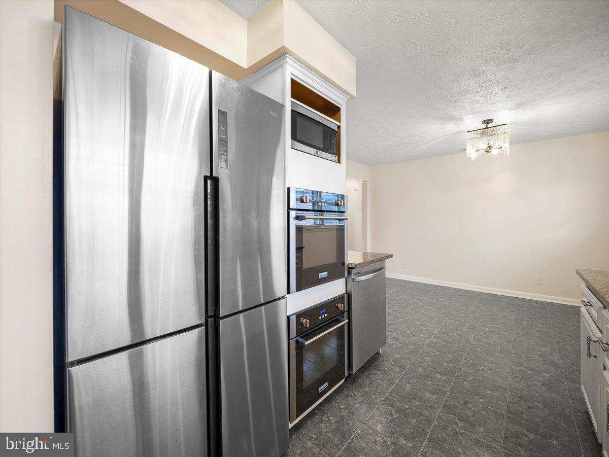 570 Welltown Road Winchester, VA 22603 - Photo 10 of 29 a metallic refrigerator freezer sitting in a kitchen