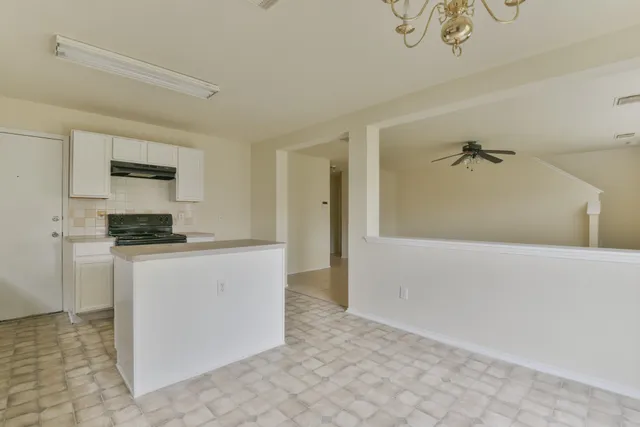 a kitchen with a refrigerator and a stove