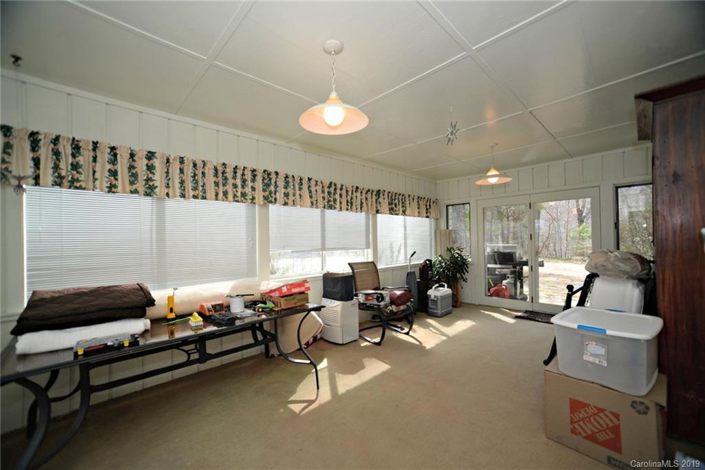 104 Little Falls Drive Tryon, NC 28782 - Photo 18 of 21 a living room with furniture a large window and gym equipment