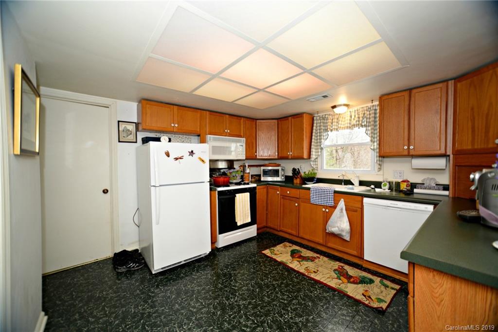 104 Little Falls Drive Tryon, NC 28782 - Photo 19 of 21 a kitchen with stainless steel appliances a refrigerator sink and cabinets