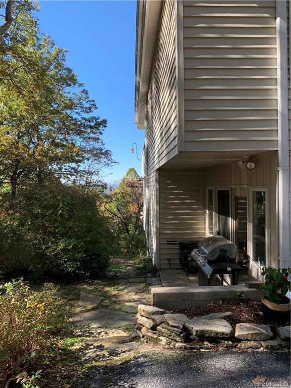 104 Little Falls Drive Tryon, NC 28782 - Photo 5 of 21 a front view of a house with swimming pool and porch