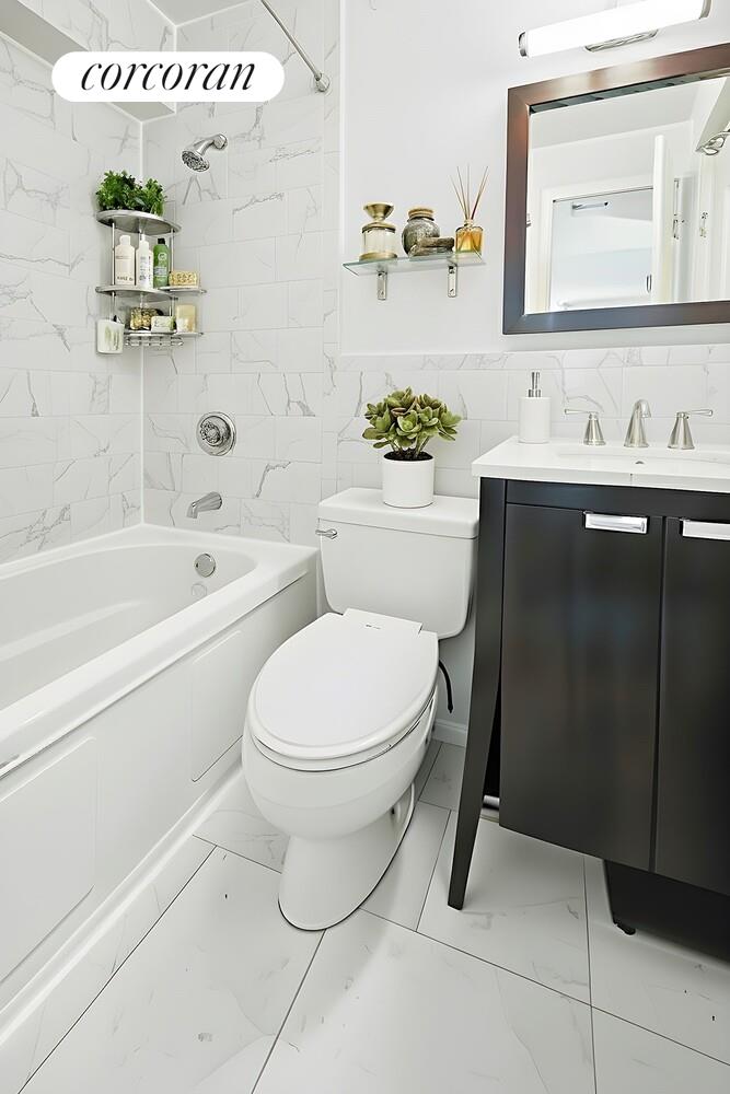 1991 Broadway, Unit 18B Manhattan, NY 10023 - Photo 8 of 9 a bathroom with a toilet sink and mirror