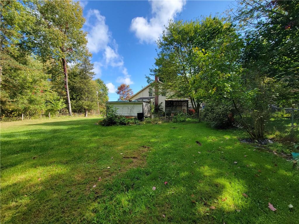 227 Crystal Spring Road Sandy Lake, PA 16145 - Photo 20 of 50 a front view of a house with a garden
