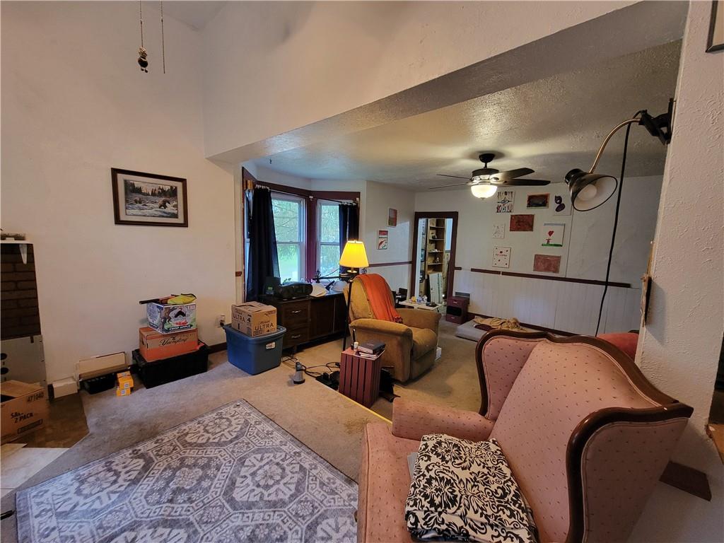 227 Crystal Spring Road Sandy Lake, PA 16145 - Photo 26 of 50 a living room with furniture and a chandelier