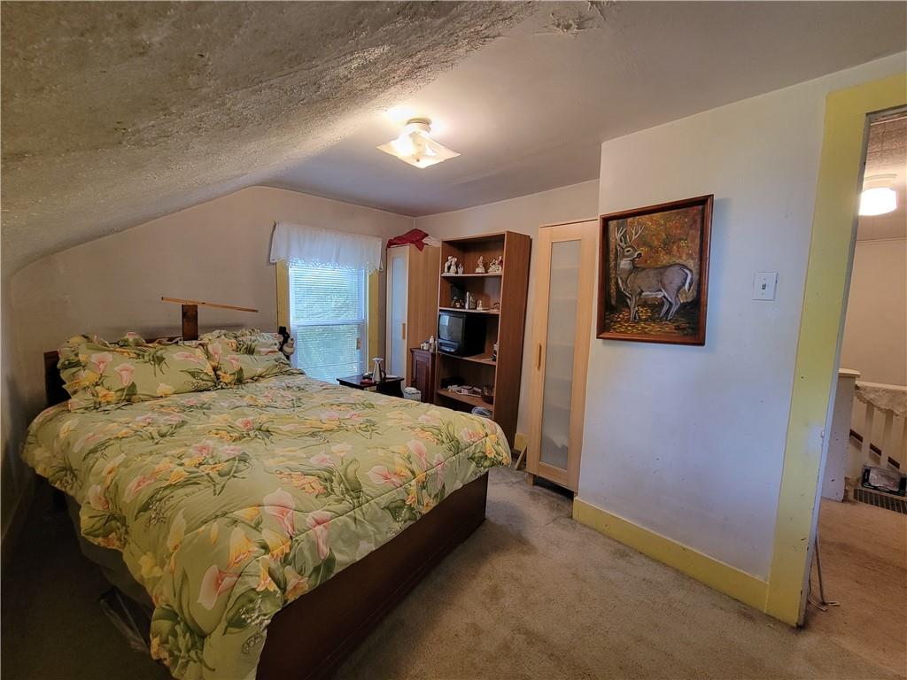 227 Crystal Spring Road Sandy Lake, PA 16145 - Photo 41 of 50 a bed sitting in a spacious bedroom next to a bedroom