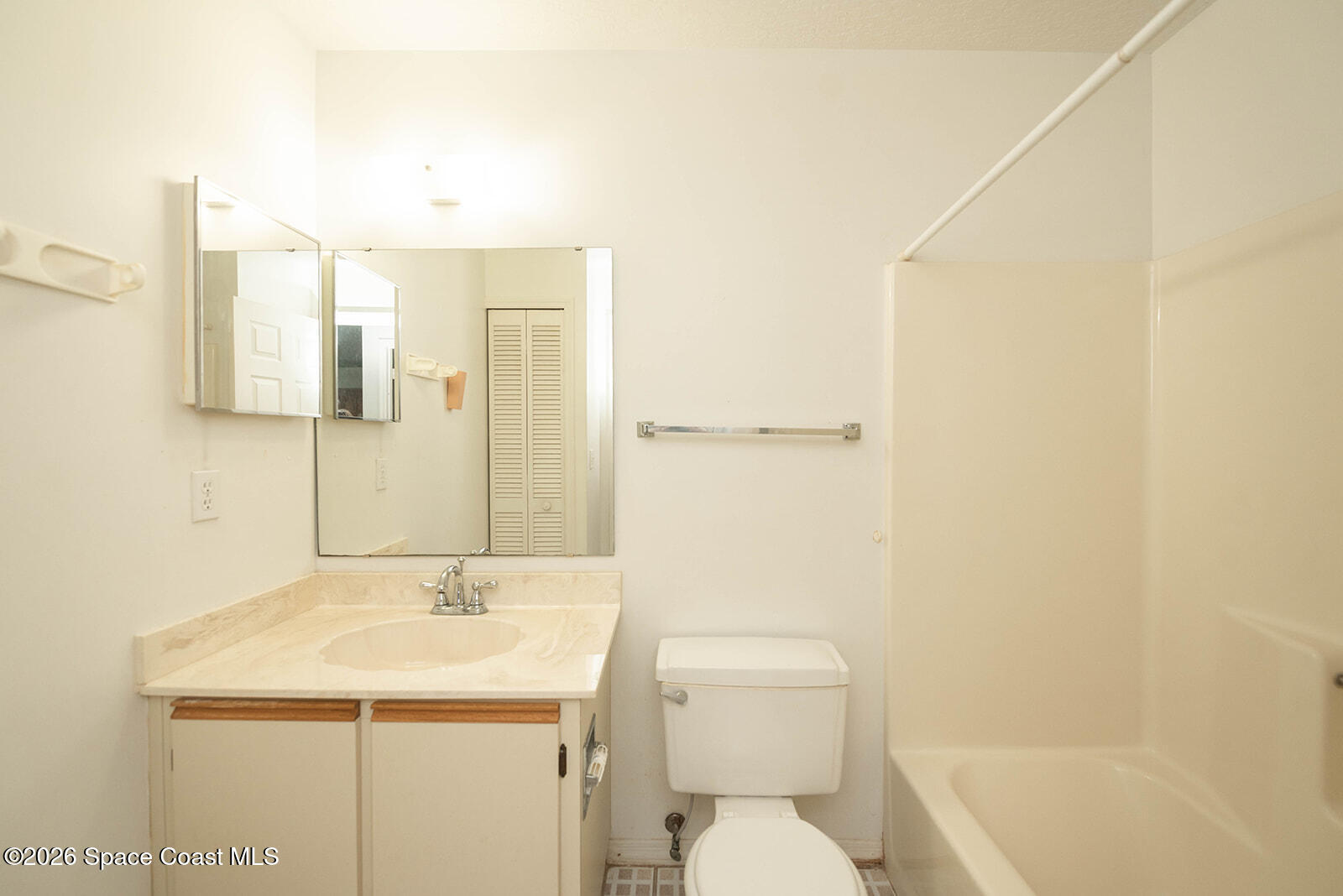 1954 Quail Ridge Court, Unit 1701 Cocoa, FL 32926 - Photo 19 of 41 a bathroom with a sink a toilet and shower