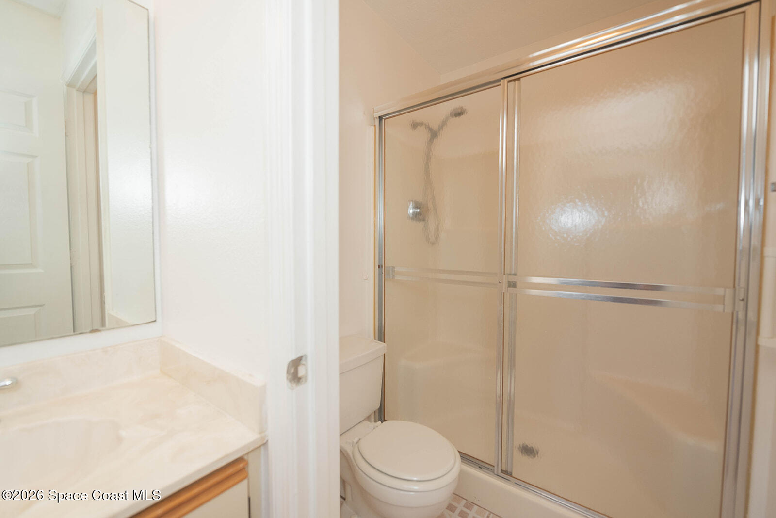 1954 Quail Ridge Court, Unit 1701 Cocoa, FL 32926 - Photo 26 of 41 a bathroom with a shower and a toilet