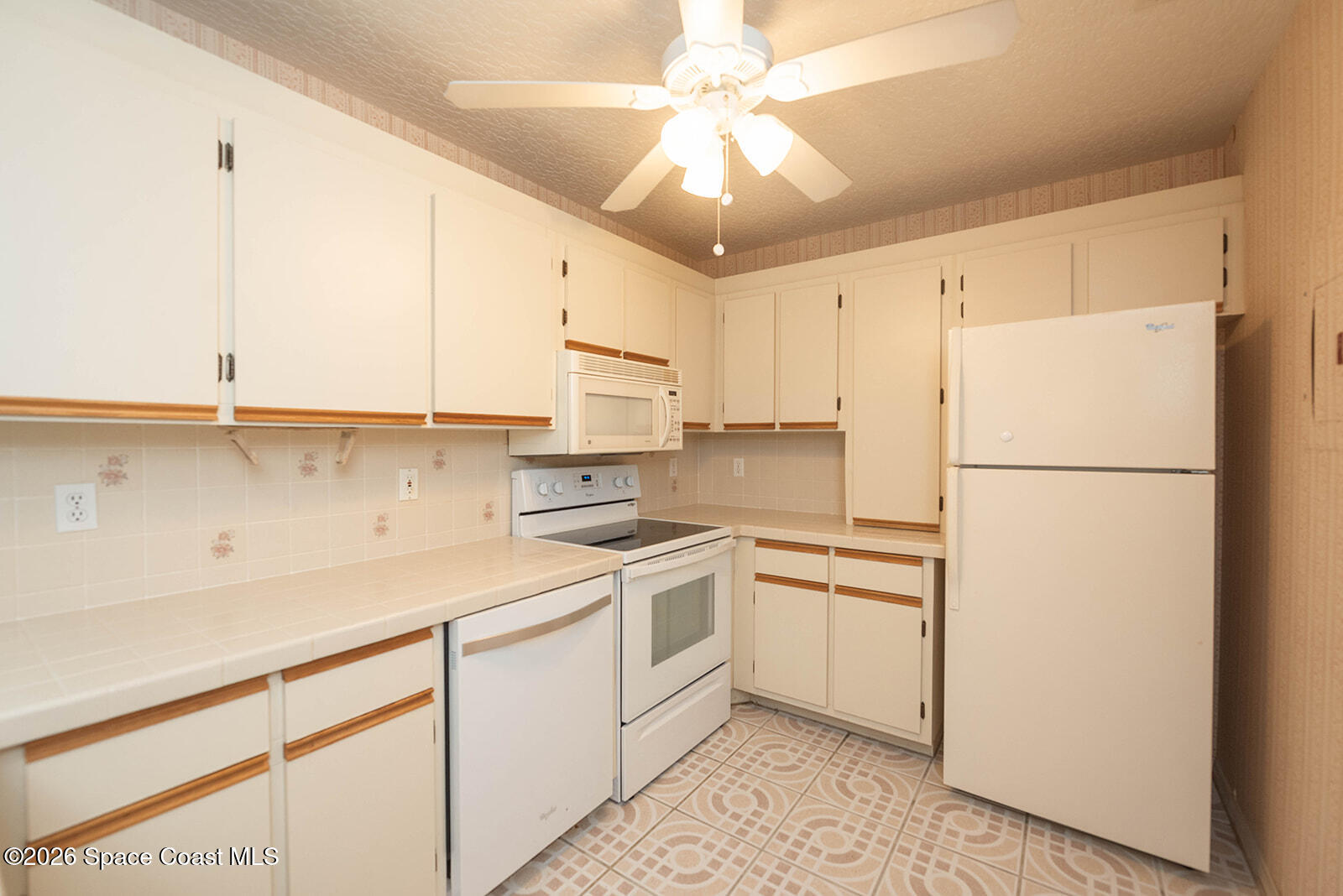 1954 Quail Ridge Court, Unit 1701 Cocoa, FL 32926 - Photo 33 of 41 a kitchen with a refrigerator a sink and dishwasher