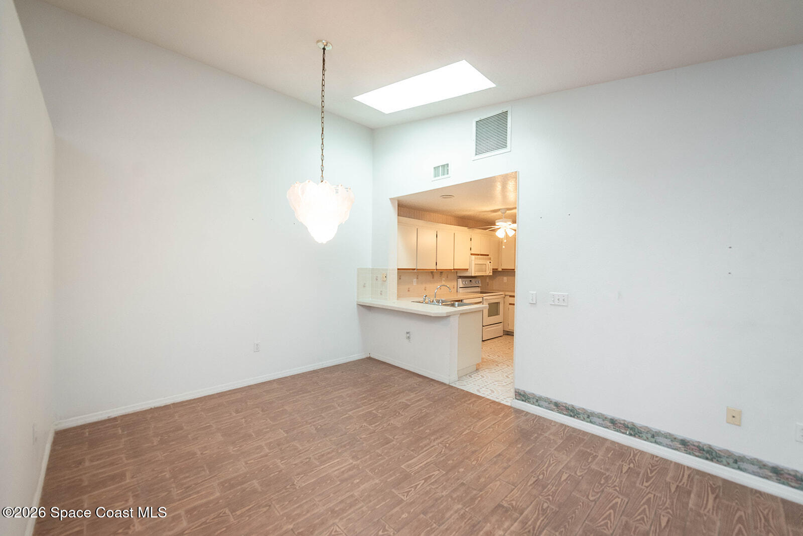 1954 Quail Ridge Court, Unit 1701 Cocoa, FL 32926 - Photo 38 of 41 a room with a white cabinets and stove