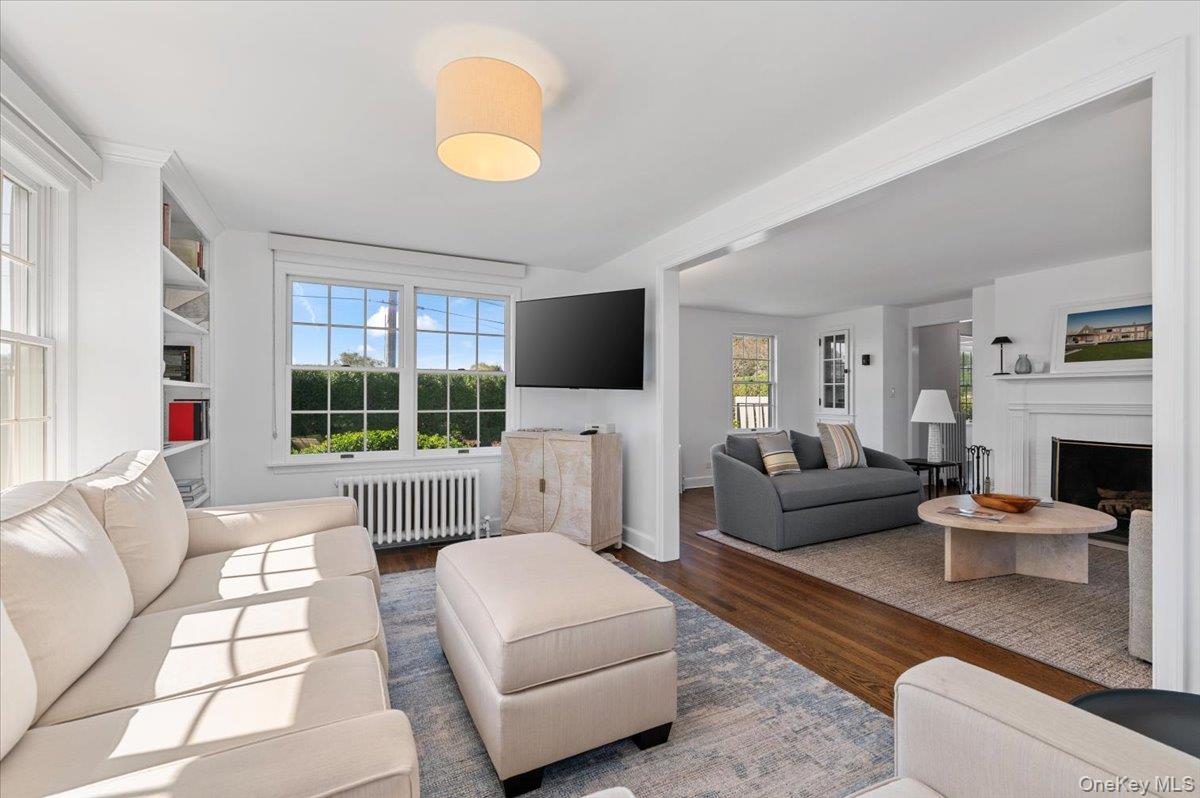 2 Strongs Lane Water Mill, NY 11976 - Photo 12 of 47 Living area featuring wood finished floors, radiator heating unit, and a fireplace