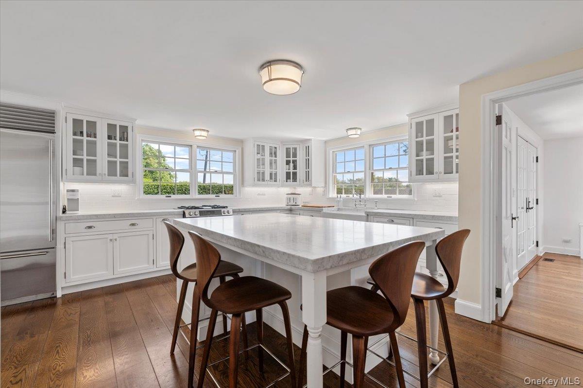 2 Strongs Lane Water Mill, NY 11976 - Photo 22 of 47 Kitchen with glass insert cabinets, tasteful backsplash, and white cabinets