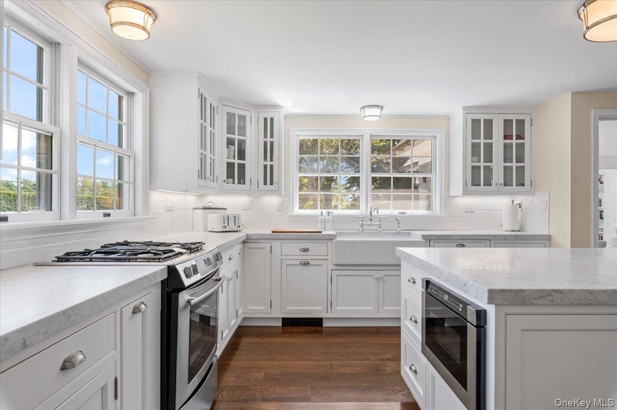 2 Strongs Lane Water Mill, NY 11976 - Photo 24 of 47 Kitchen featuring stainless steel gas range, glass insert cabinets, white cabinetry, and light stone counters