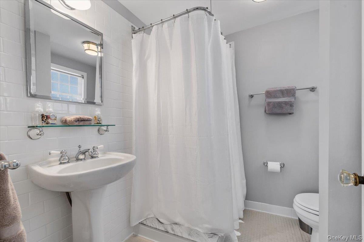 2 Strongs Lane Water Mill, NY 11976 - Photo 29 of 47 Full bathroom with a stall shower, tile walls, and light tile patterned flooring