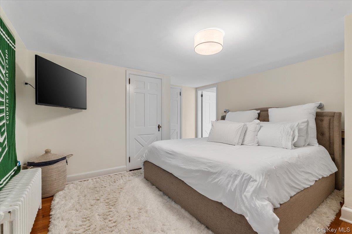 2 Strongs Lane Water Mill, NY 11976 - Photo 32 of 47 Bedroom featuring radiator and wood finished floors