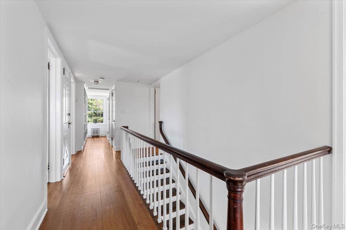 2 Strongs Lane Water Mill, NY 11976 - Photo 35 of 47 Hall with an upstairs landing, dark wood-style floors, and radiator