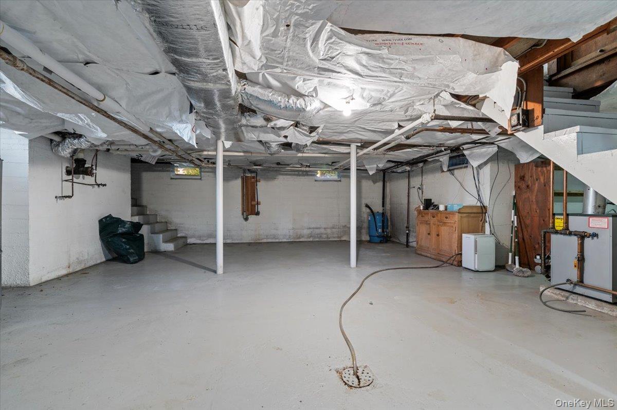 2 Strongs Lane Water Mill, NY 11976 - Photo 41 of 47 Unfinished below grade area with stairs and a water pressure tank