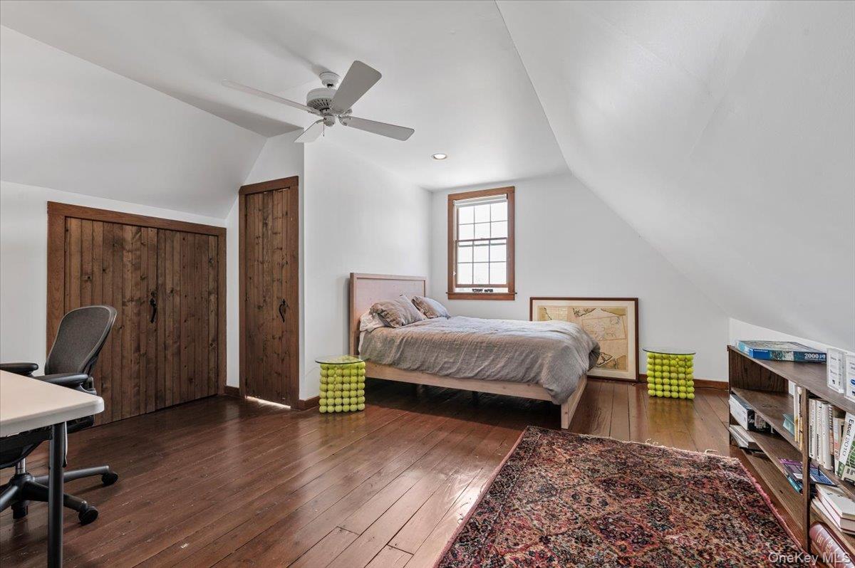 2 Strongs Lane Water Mill, NY 11976 - Photo 44 of 47 Bedroom featuring vaulted ceiling, dark wood-type flooring, an office area, a ceiling fan, and a closet
