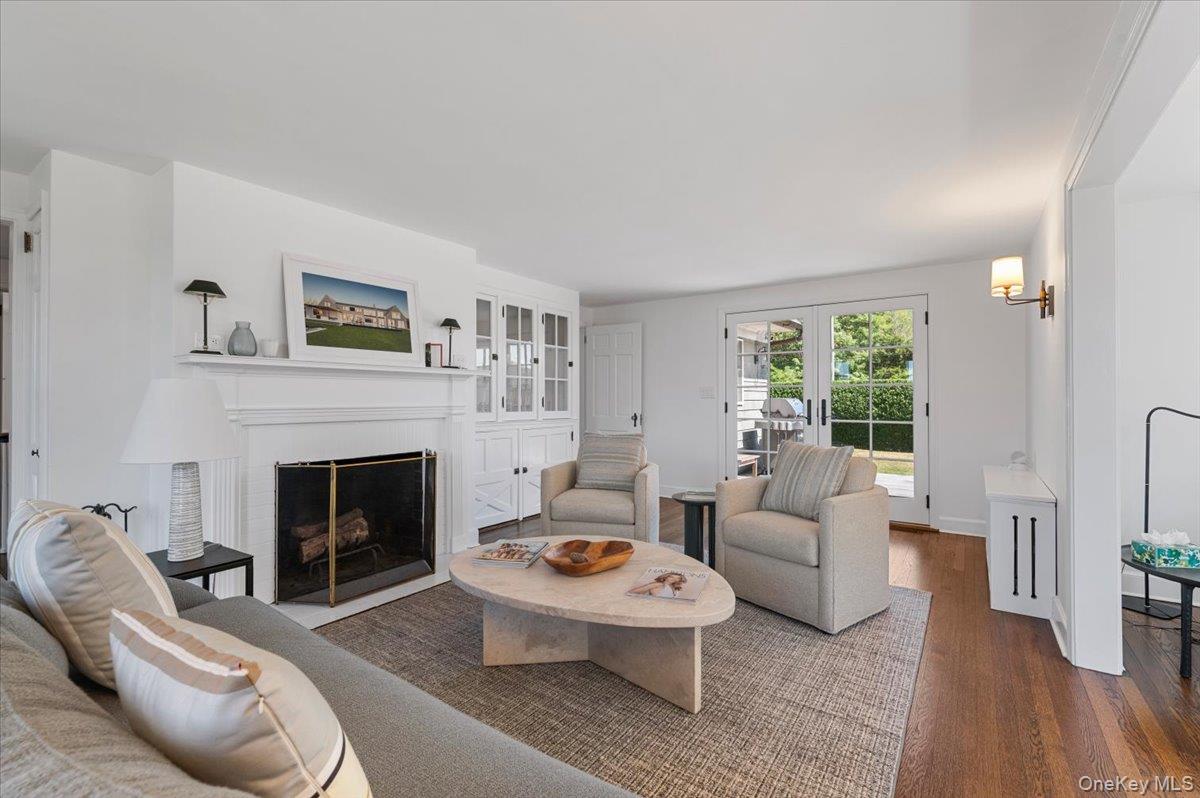 2 Strongs Lane Water Mill, NY 11976 - Photo 8 of 47 Living room with wood finished floors, a fireplace with flush hearth, and french doors