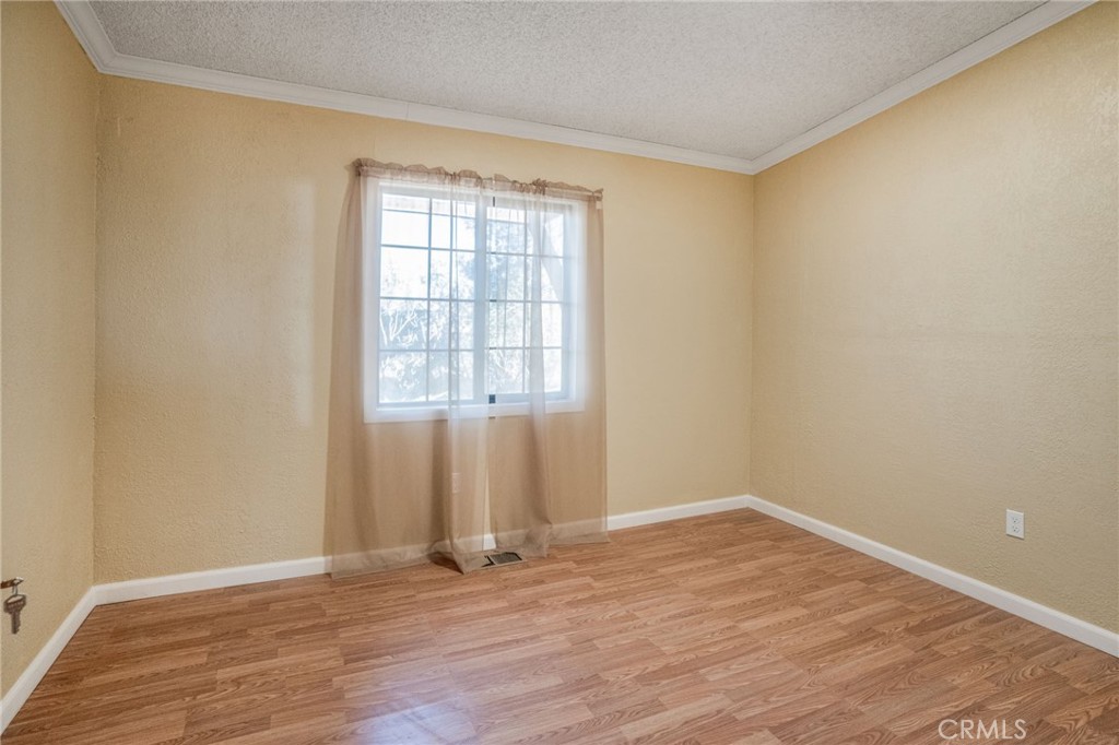 49750 3 Points Road Lancaster, CA 93536 - Photo 12 of 67 an empty room with wooden floor and windows