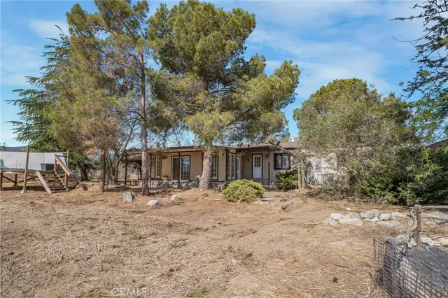 a backyard of a house with outdoor seating