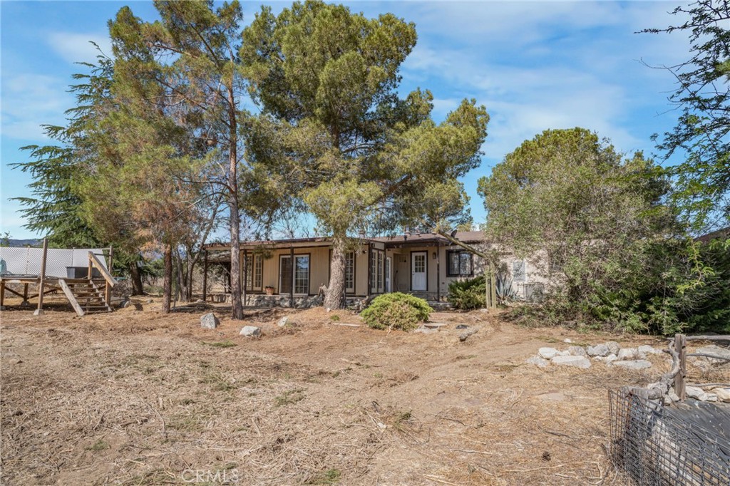 49750 3 Points Road Lancaster, CA 93536 - Photo 36 of 67 a backyard of a house with table and chairs under an large tree