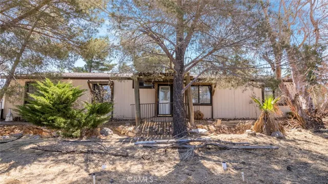 a view of a white house with a outdoor space