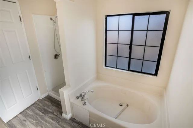 a bathroom with a tub and a shower