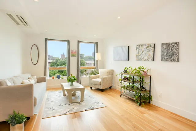 a living room with furniture and a floor to ceiling window