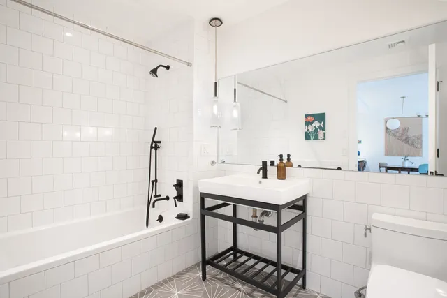 a bathroom with a sink toilet and shower
