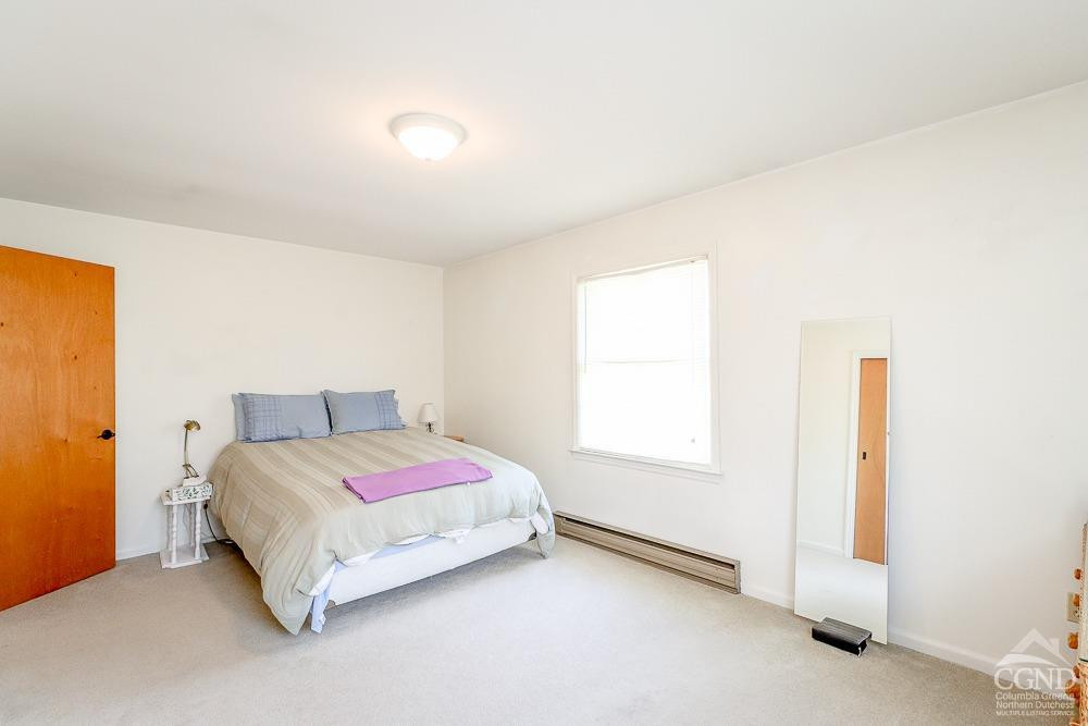 167 Highway 23 Claverack, NY 12513 - Photo 8 of 23 a bedroom with a bed and a window