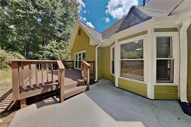 a view of backyard with a deck and furniture