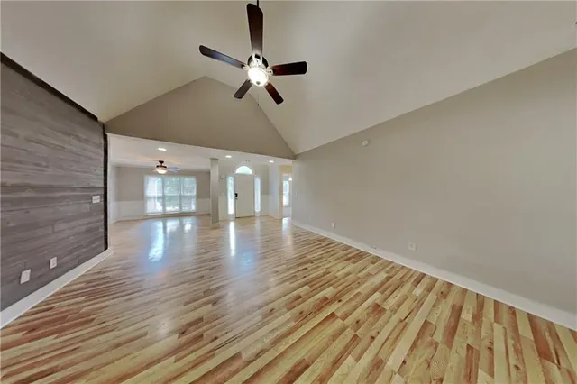 a view of empty room with wooden floor