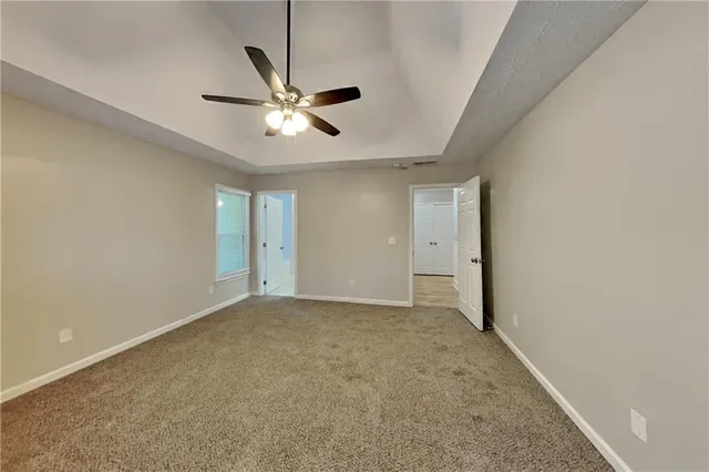 a view of an empty room with a ceiling fan
