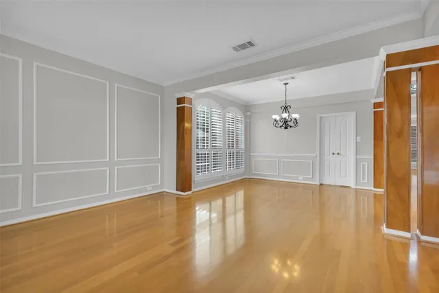 a view of wooden floor and windows in a room