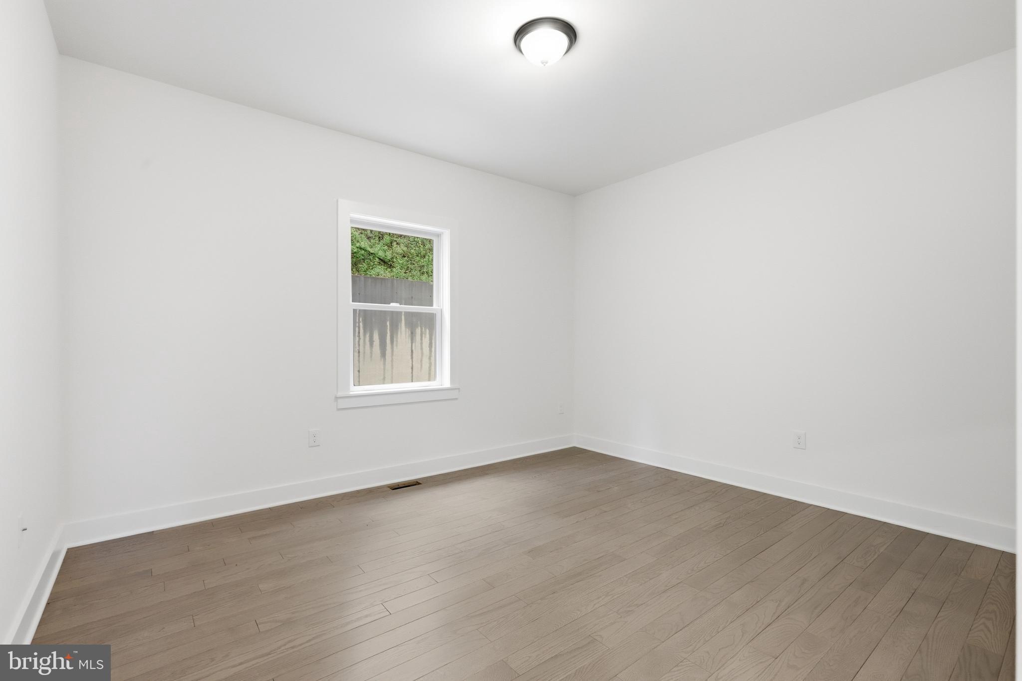 759 River Road Erwinna, PA 18920 - Photo 20 of 46 an empty room with wooden floor and windows
