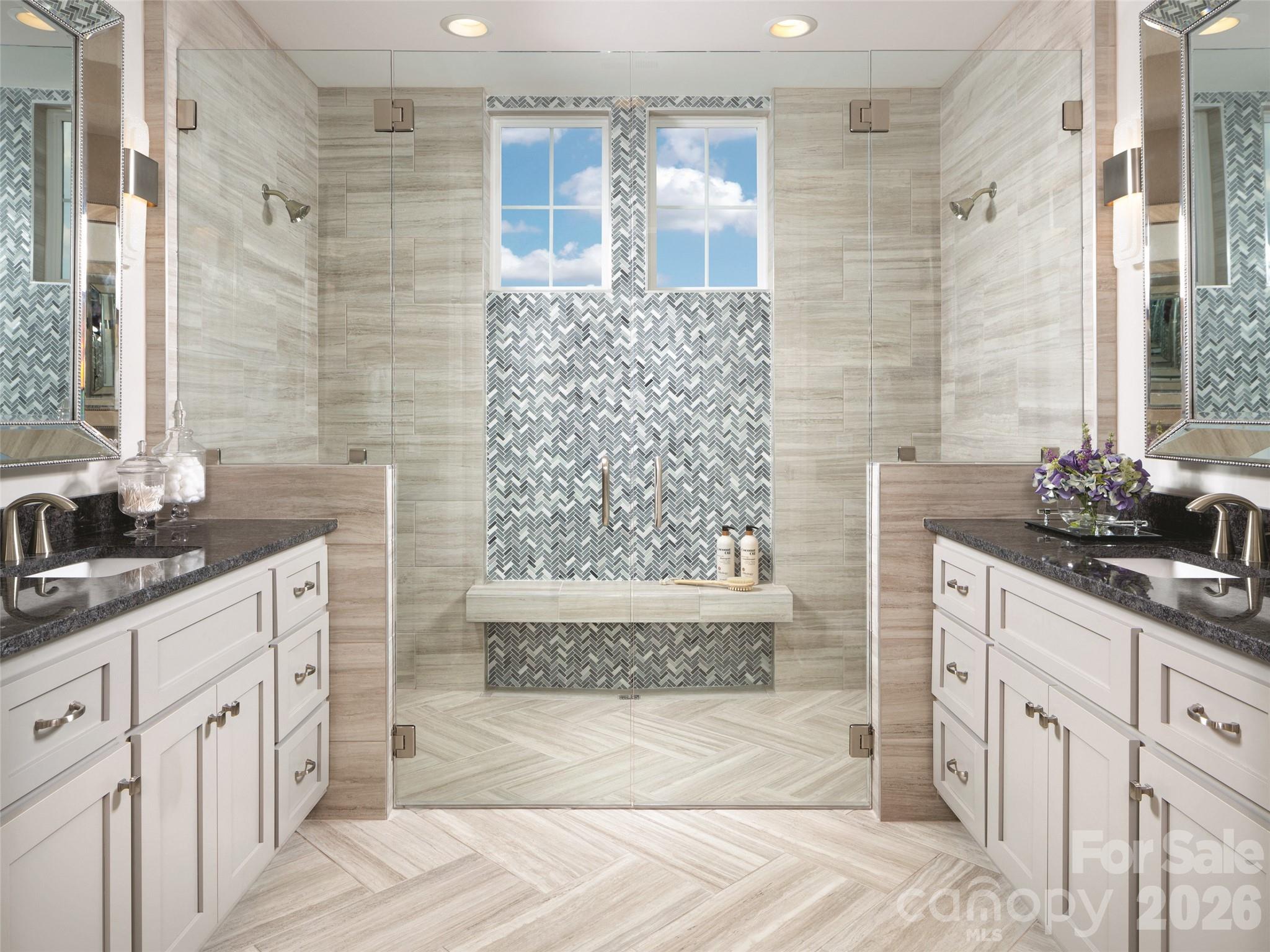 142 Elkton Court Mill Spring, NC 28756 - Photo 6 of 24 a bathroom with a double vanity sink a toilet a mirror and shower