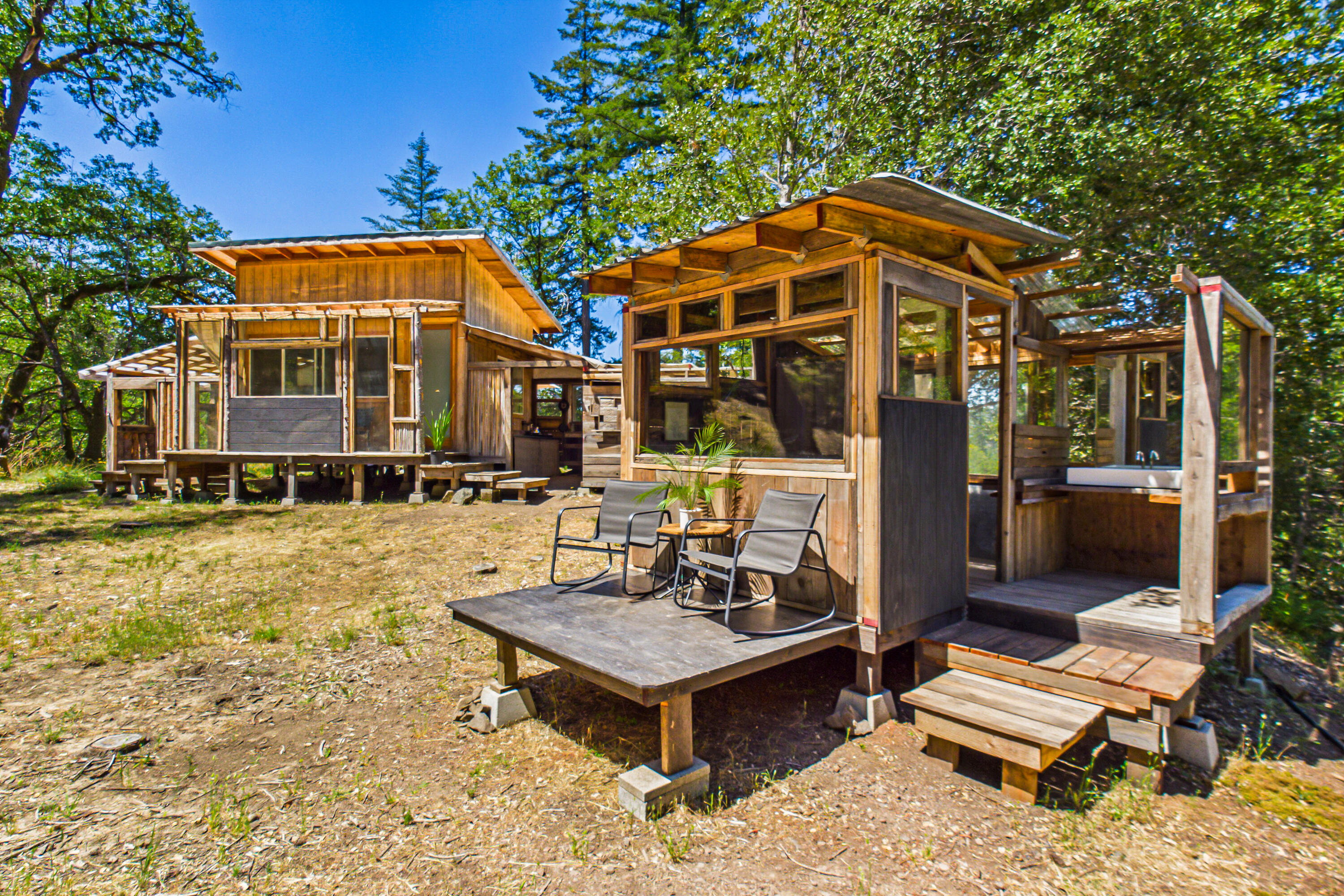 60890 Bell Springs Road Laytonville, CA 95454 - Photo 27 of 77 a backyard of a house with barbeque oven table and chairs