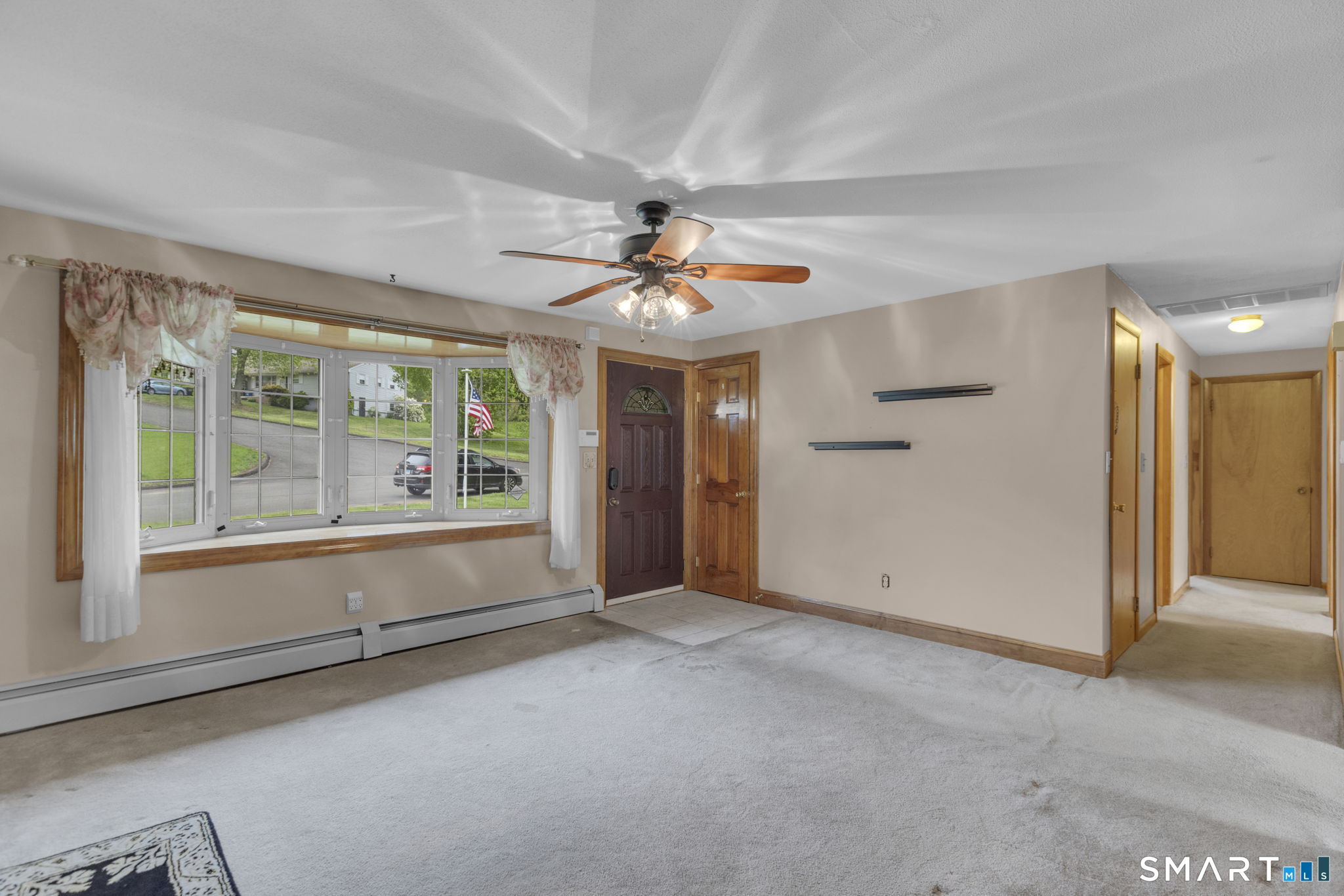 102 Wayne Lane Meriden, CT 06450 - Photo 6 of 36 a view of a livingroom with a ceiling fan and window