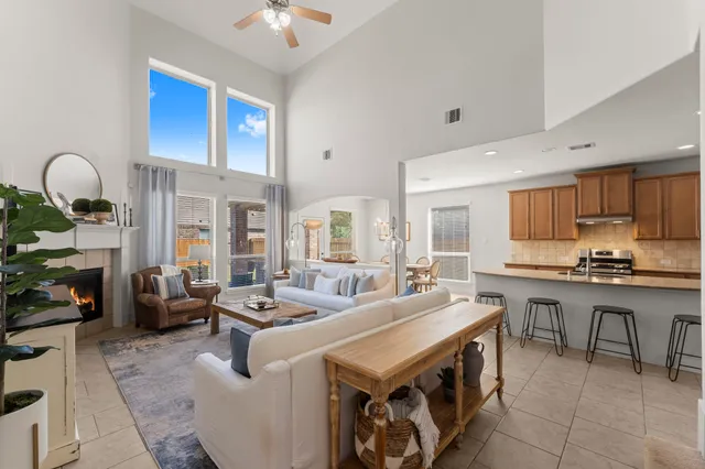 a large kitchen with kitchen island a stove a sink a dining table and chairs with wooden floor