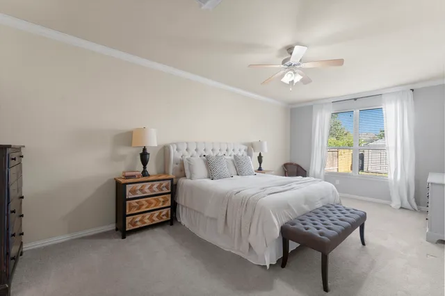 a bedroom with a bed chairs and window