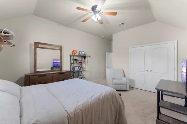 a bedroom with a bed and a chandelier
