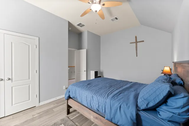 a bedroom with a bed and a chandelier