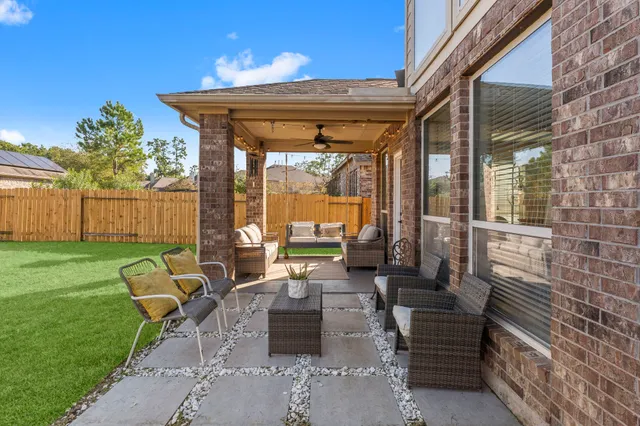 a view of a patio with couches chairs and potted plants