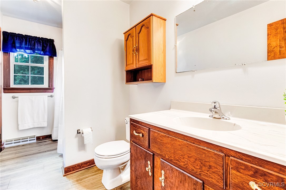 3050 Rose Mount Road Walkerton, VA 23177 - Photo 13 of 35 Bathroom featuring vanity, toilet, and hardwood /